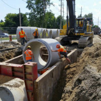 Crew installing sewers